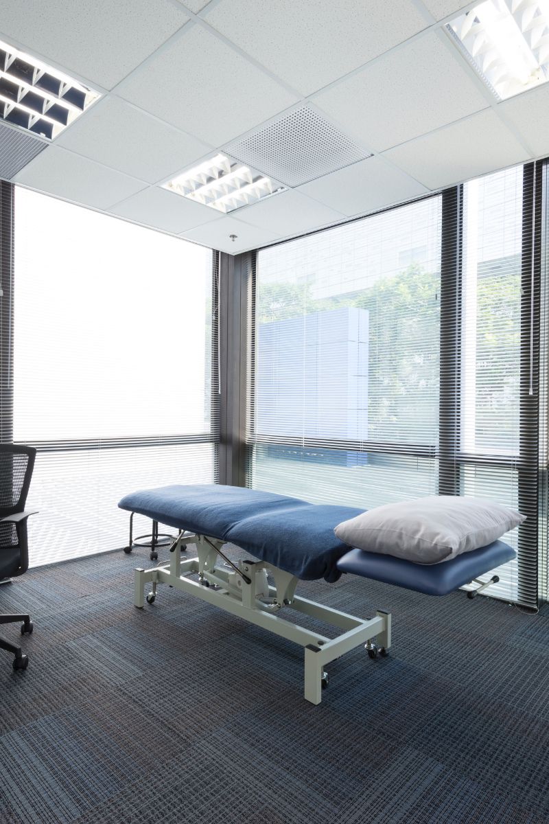 An office room equipped with massage table and chairs for No-Fault and Workers Compensation Doctors.