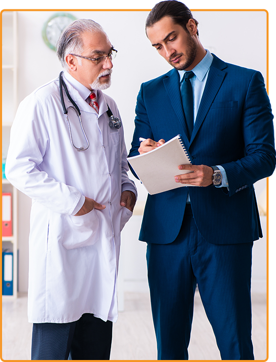 A doctor in a white coat listens as a man in a blue suit takes notes on a clipboard, discussing New York No-Fault claims. They stand in a well-lit room with clock and shelves subtly framing this professional exchange. A doctor in a white coat listens as a man in a blue suit takes notes on a clipboard, discussing New York No Fault claims They stand in a well lit room with clock and shelves subtly framing this professional exchange