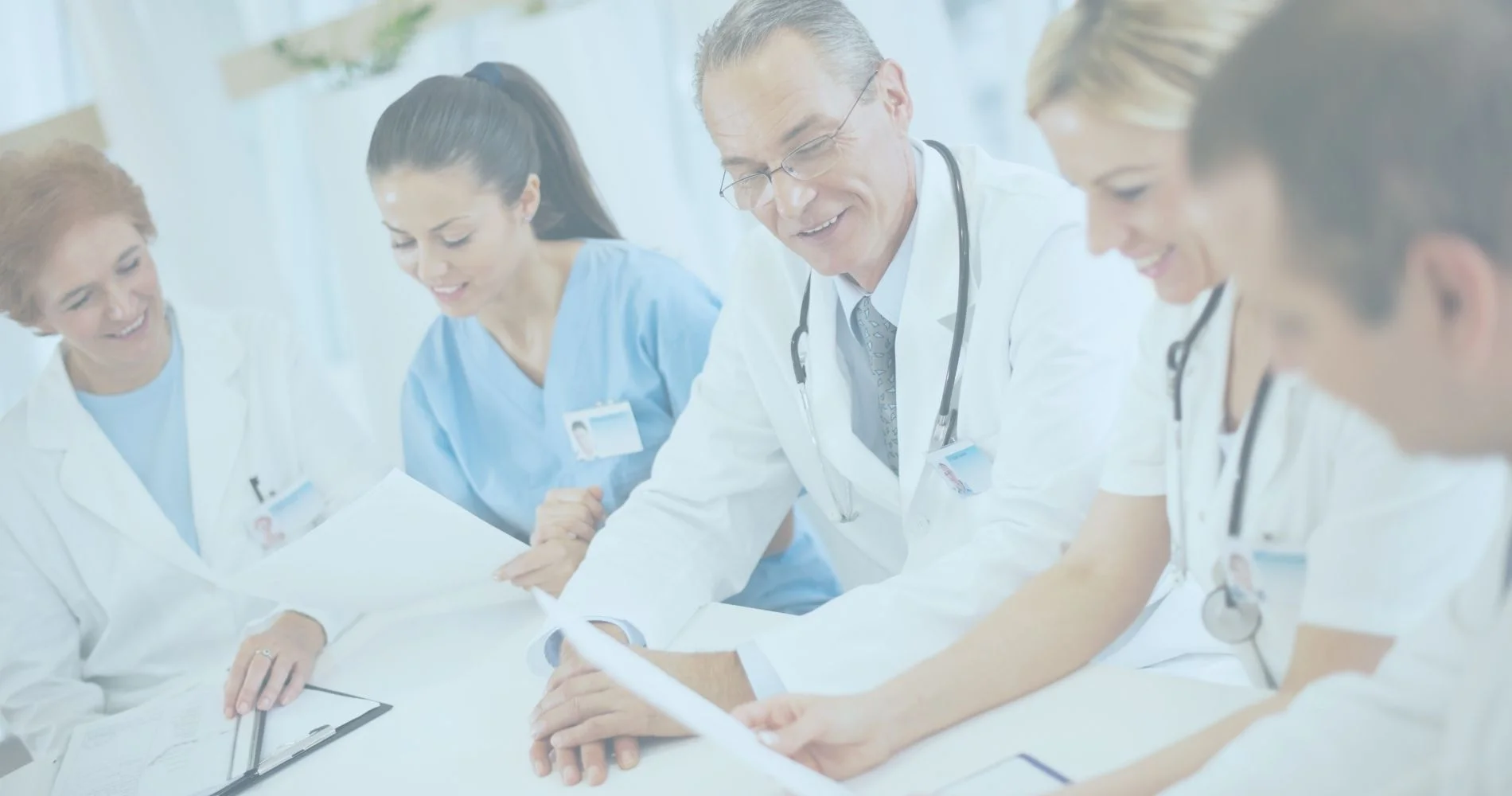 A group of No-Fault and Workers Compensation doctors sitting around a table.